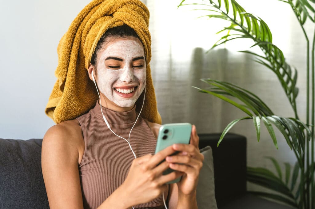 Person looking at phone with face mask