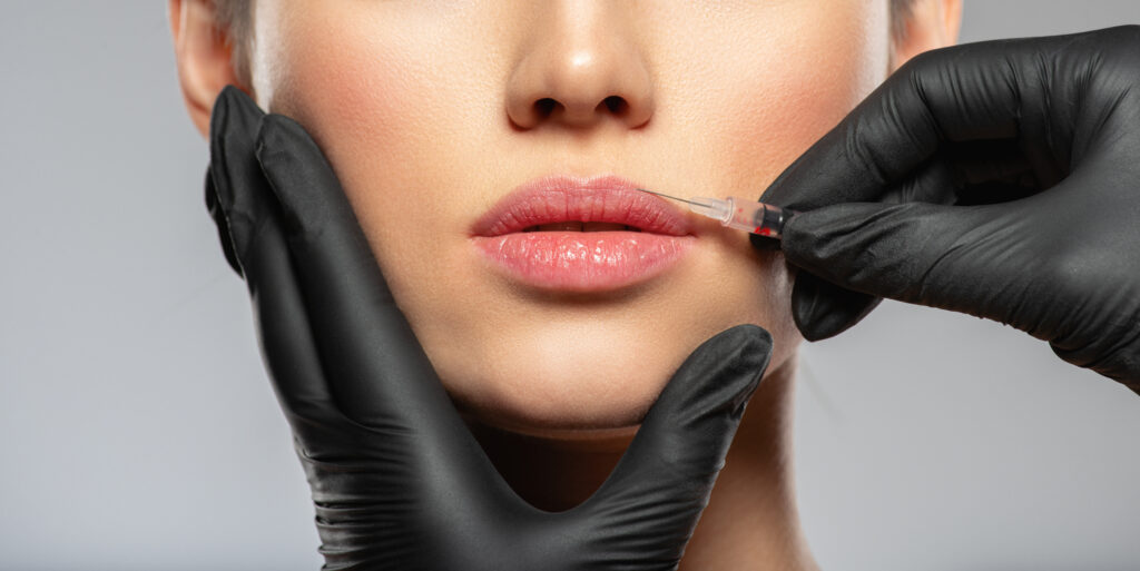 Person receiving botox injection in lips